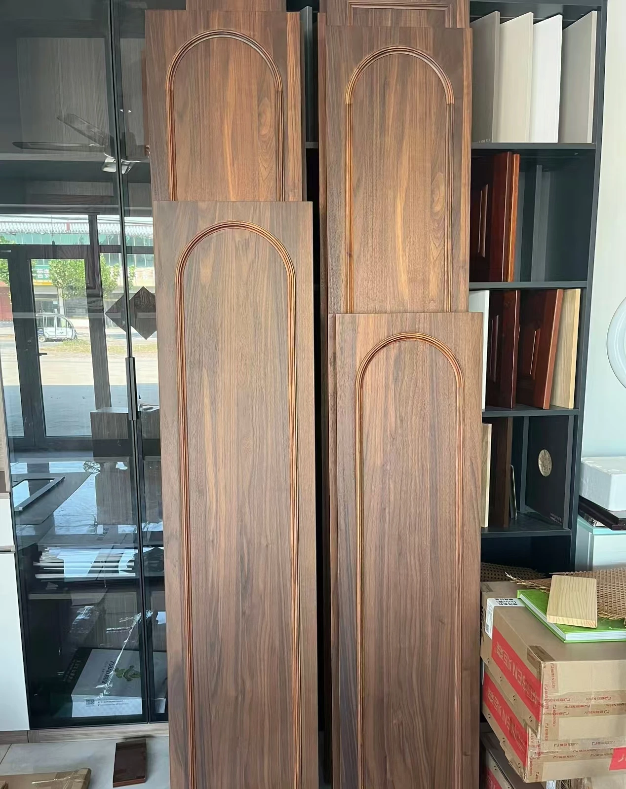 Black walnut cabinet door samples with tall arched raised-panel profiles.