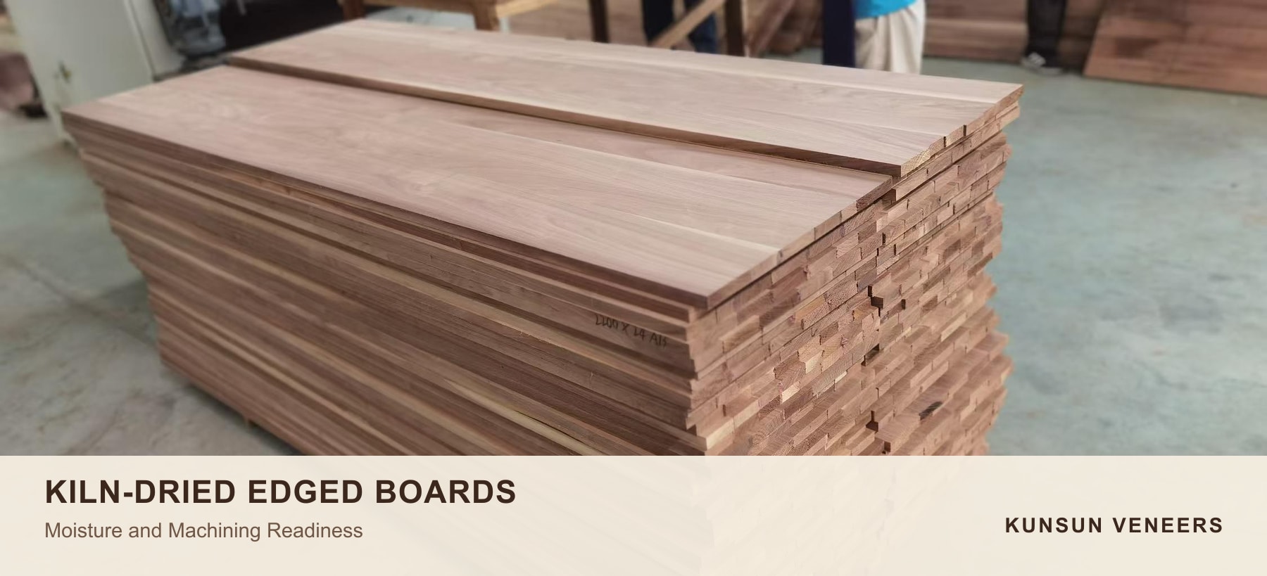 Kiln-dried and edged black walnut boards stacked for inspection and machining.