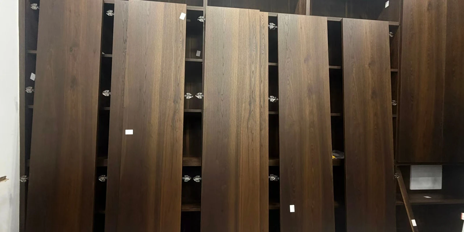 Dark decorative surfaces showing differences in tone and grain between panels.