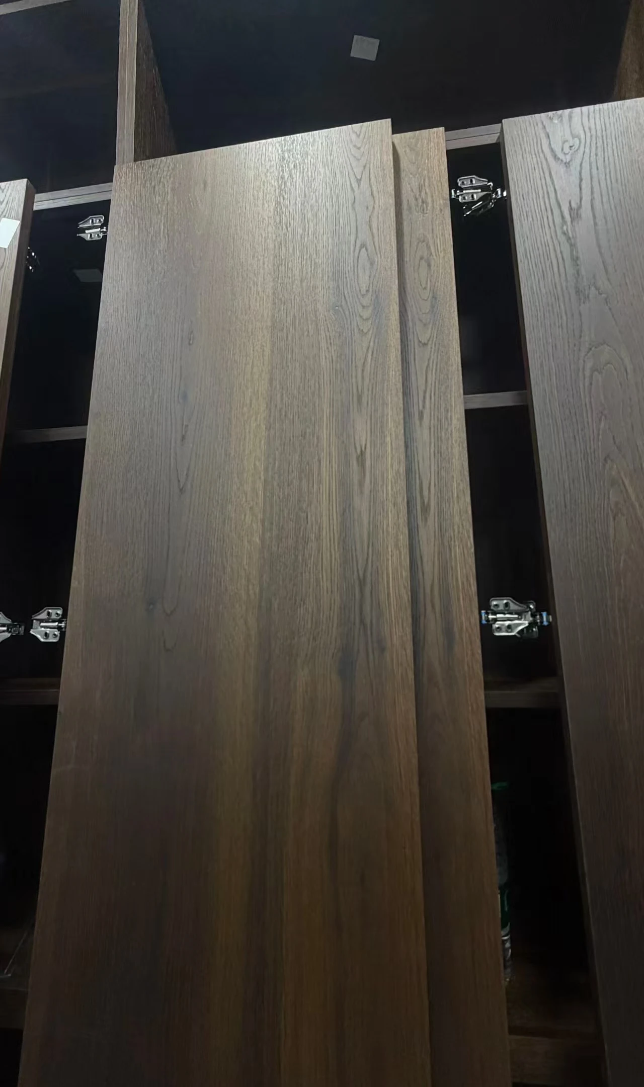 Close view of vertical grain and tonal variation on a decorative surface.