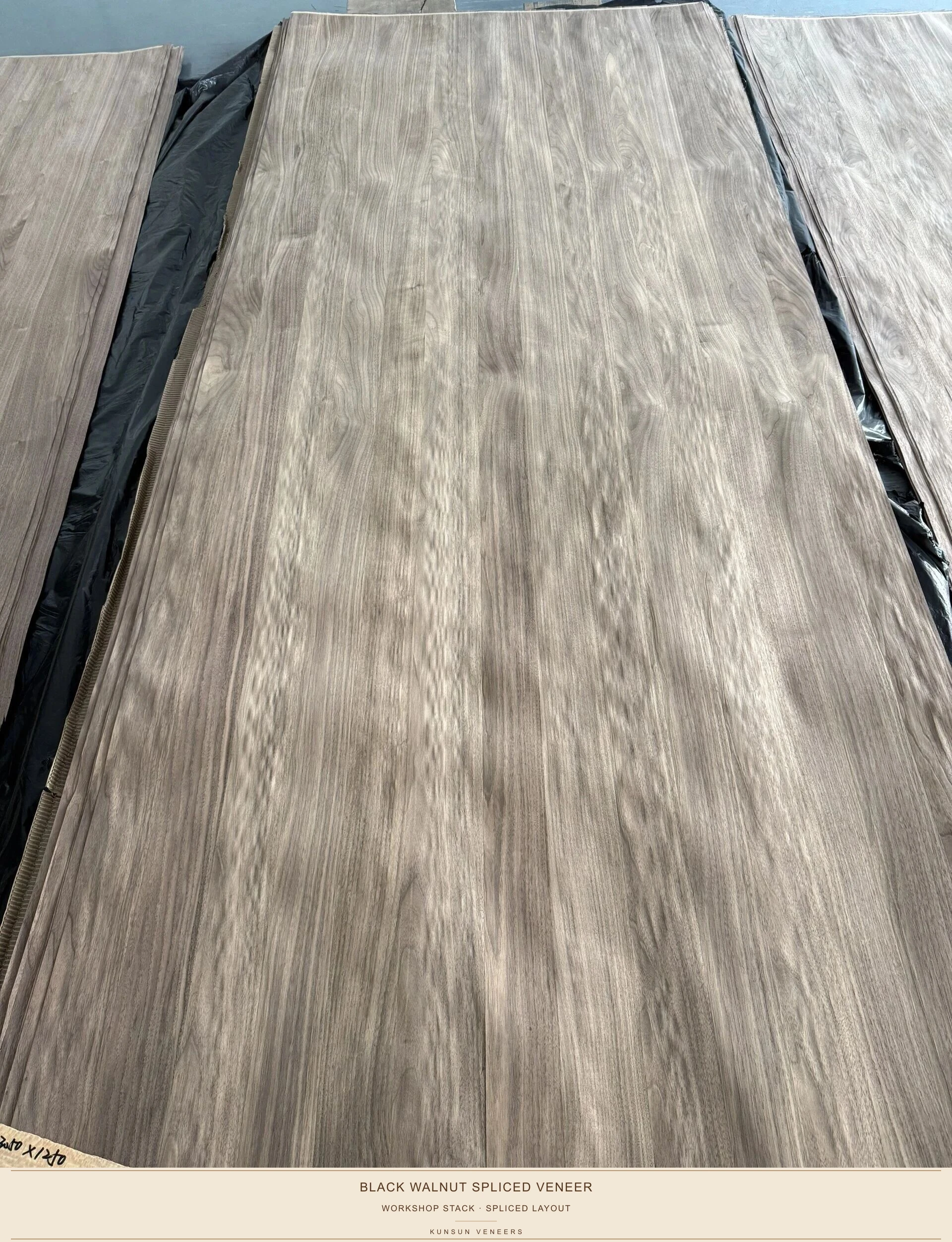 Workshop view of stacked spliced black walnut veneer facings prepared for panel lamination.