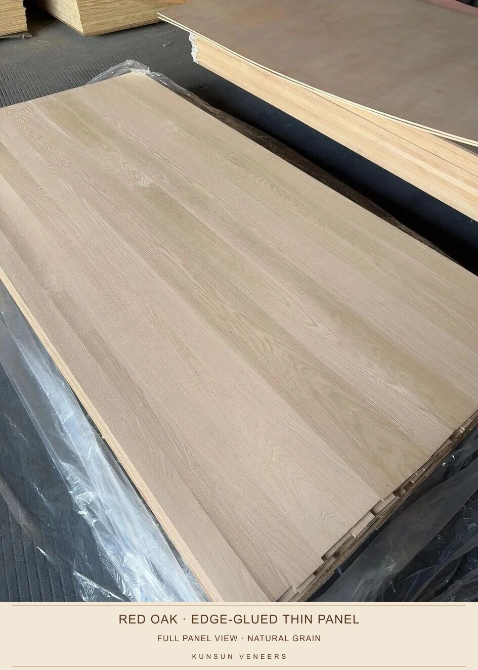 Angled workshop view of red oak edge-glued thin panels showing full-length joints, natural grain and stacked edges.