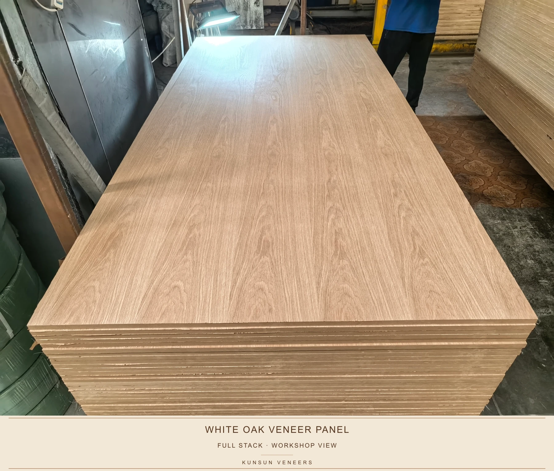 Full stack of white oak crown-grain MDF veneer panels in the workshop.