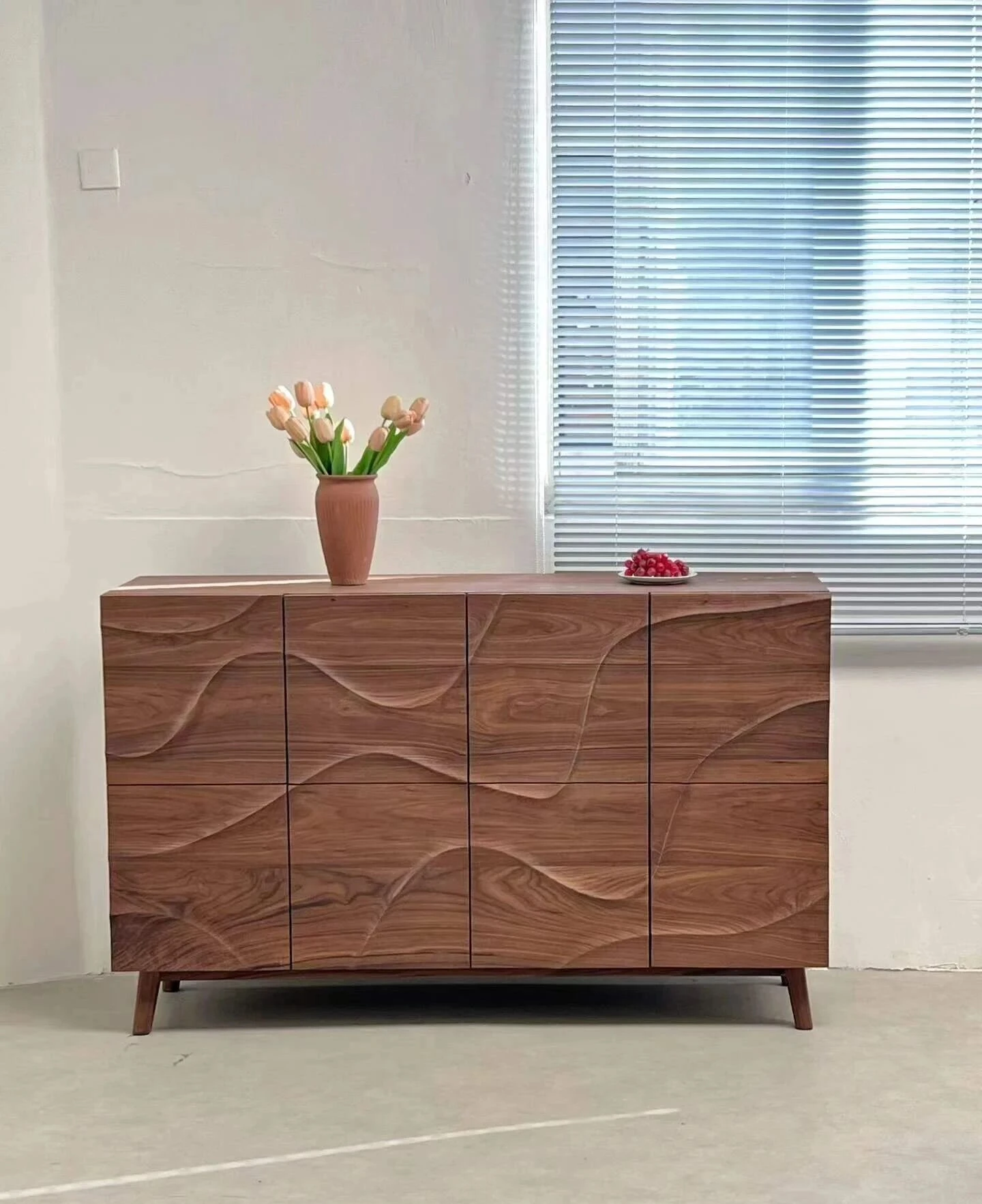 Nogal negro sideboard with sculpted doors and continuous natural grain